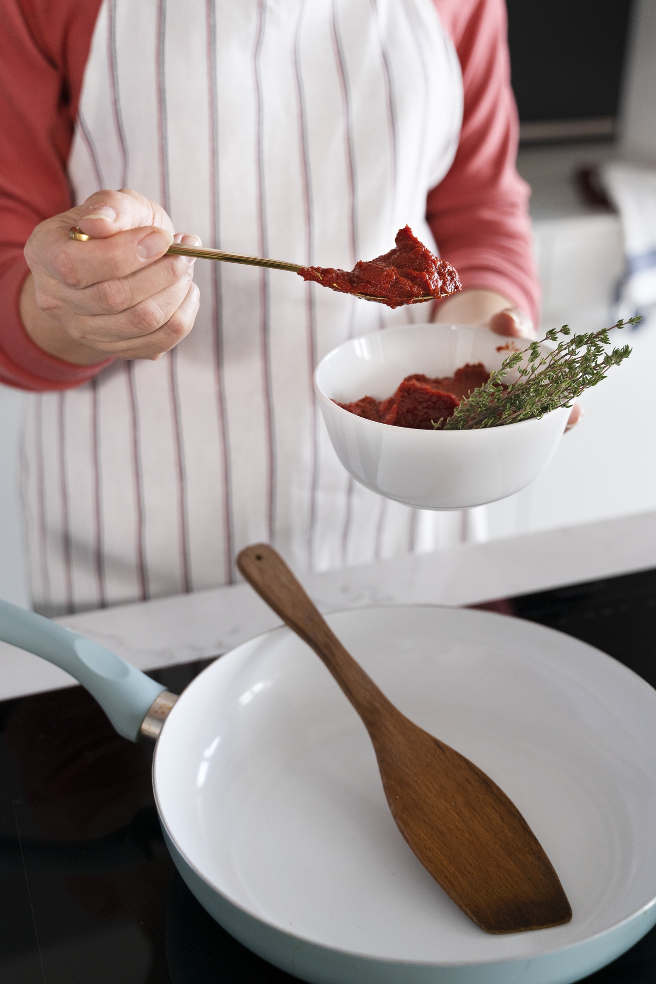 Cook tasting sauce during fast prep